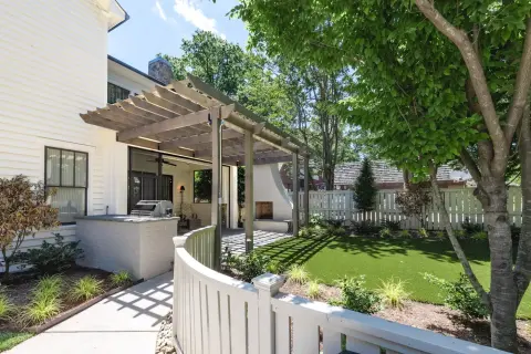 Illustrative concept visualization of the simulated backyard with a pergola, outdoor kitchen, paths and layered planting